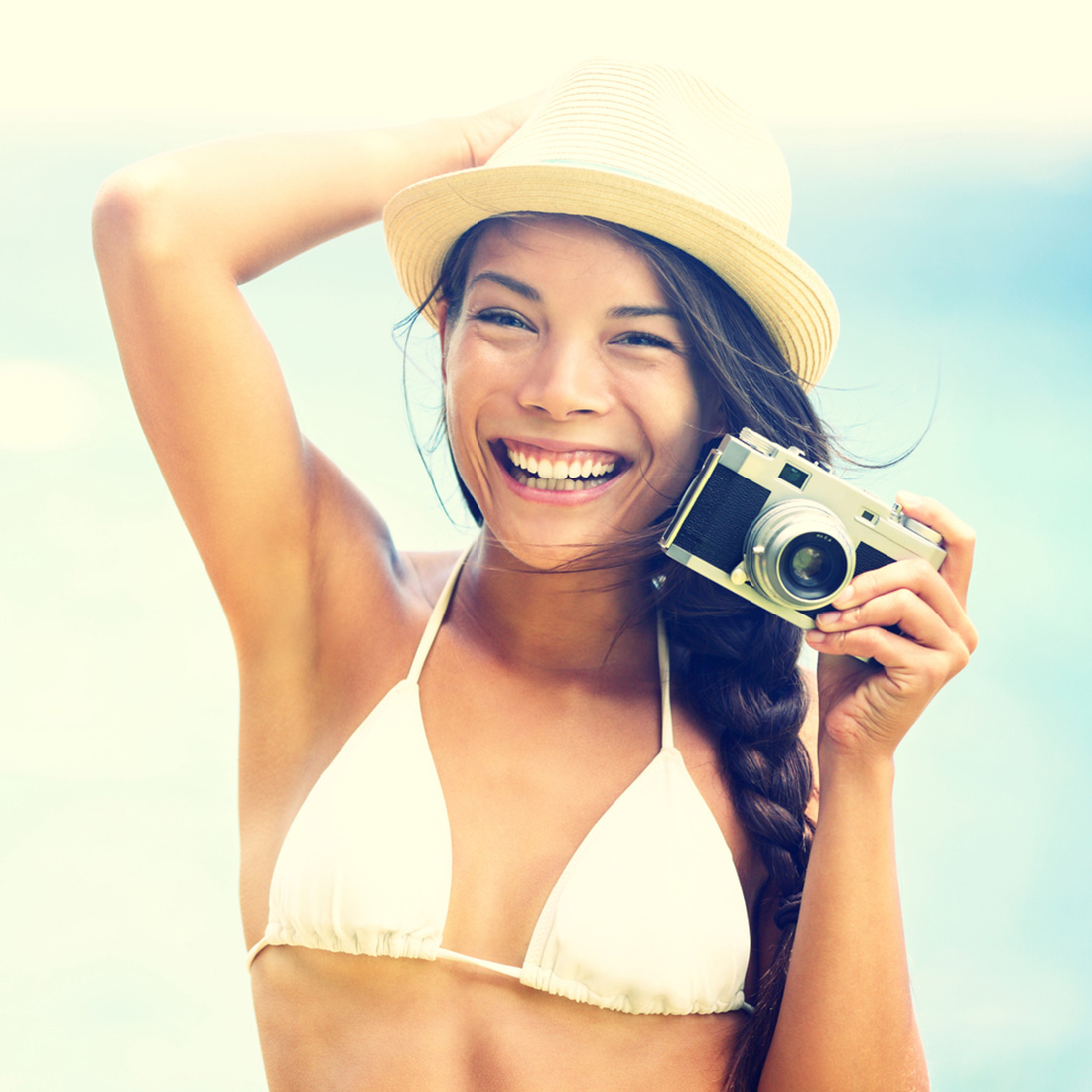 Beach woman with vintage retro camera
